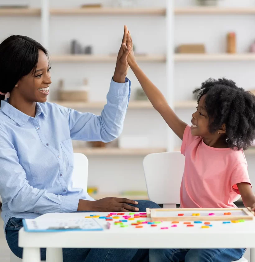 happy-little-black-girl-giving-her-teacher-high-fi-2022-10-07-02-42-48-utc